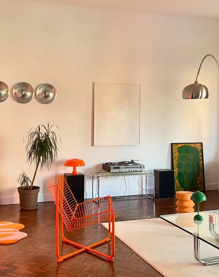 Budapest apartment interior orange wire chair arc lamp parquet floor and warm lamplight